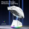 White Attack Shark X11 mouse hovering over its magnetic charging station with a vibrant streaming RGB light ring.