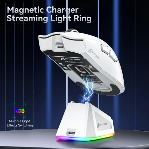 White Attack Shark X11 mouse hovering over its magnetic charging station with a vibrant streaming RGB light ring.